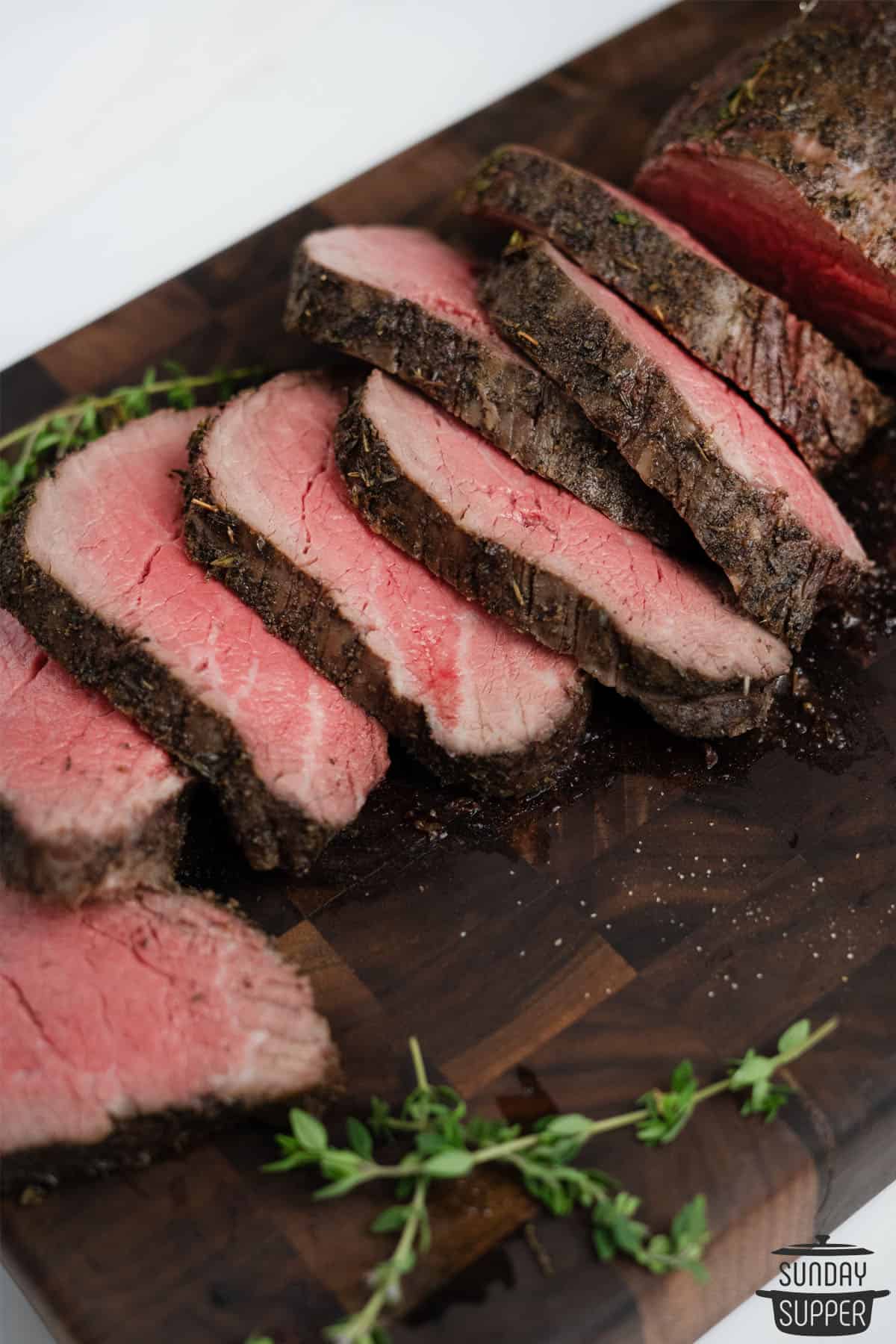 slices of beef tenderloin on a wood cutting board