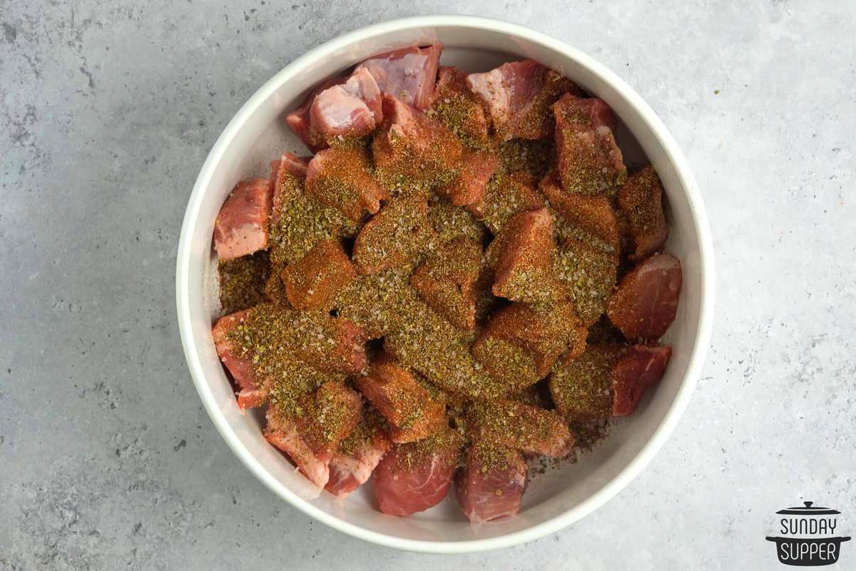 sliced pork chunks in a bowl covered with seasonings