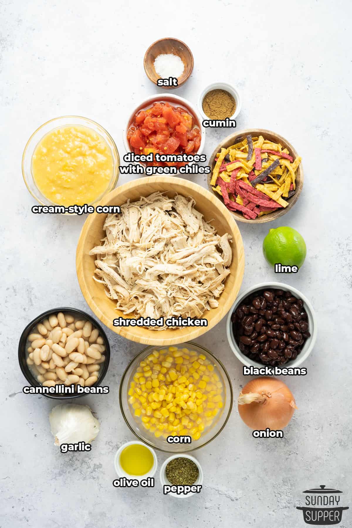 Ingredients to make Chick-fil-A Chicken Tortilla Soup with labels on a white surface