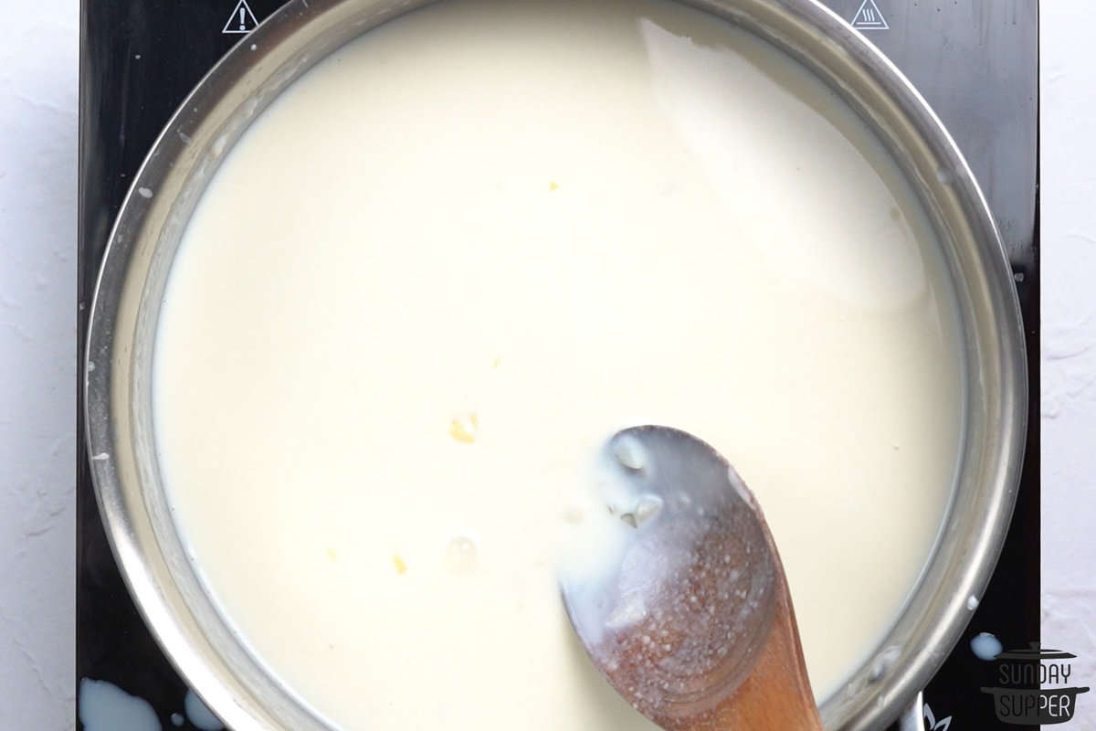 stirring milk mixture for creamed spinach
