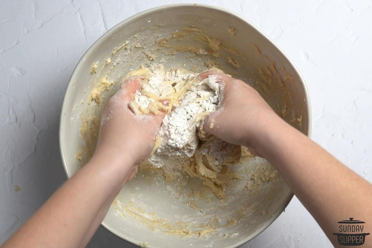 mixing dough for fast dinner rolls with hands