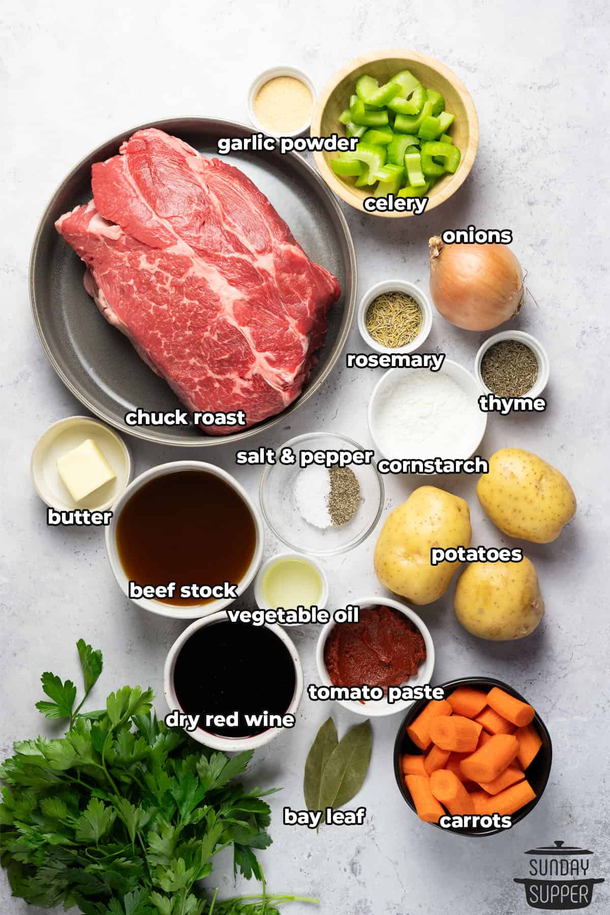 ingredients to make slow cooker chuck roast on a table with labels