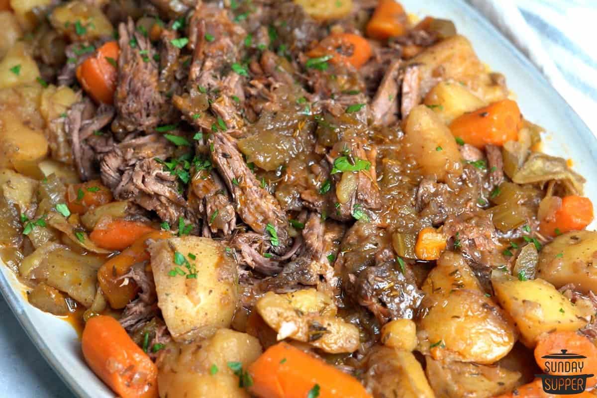 slow cooker roast up close with potatoes and carrots