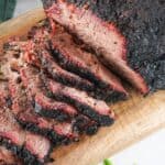 brisket sliced on a wood cutting board