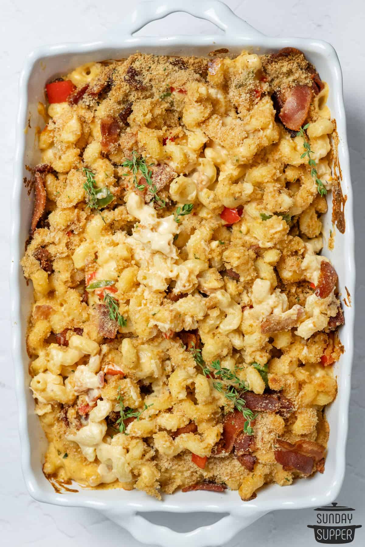 bacon mac and cheese in a white casserole dish