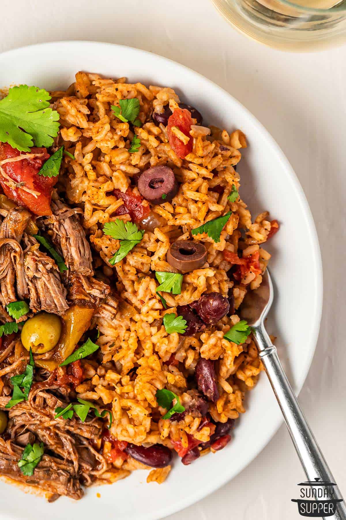 completed spanish rice with ropa vieja on a plate
