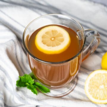 a lemon slice in a glass of starbucks medicine ball tea