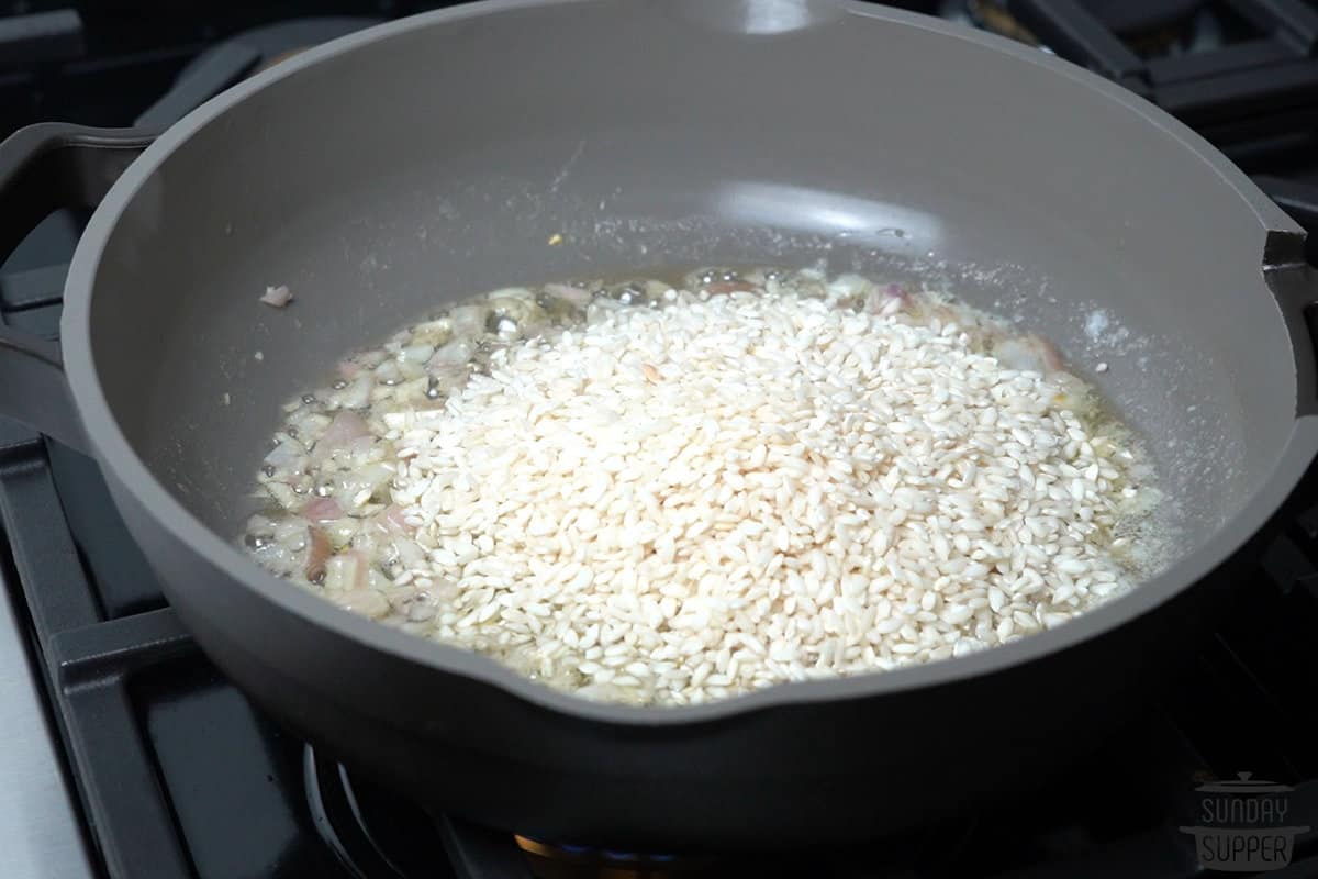 adding rice to the pan