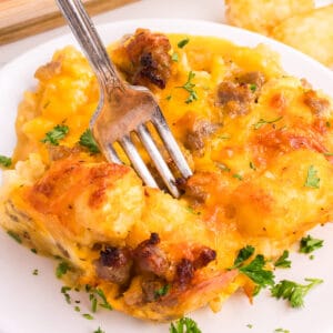 tater tot breakfast casserole on a plate with a fork