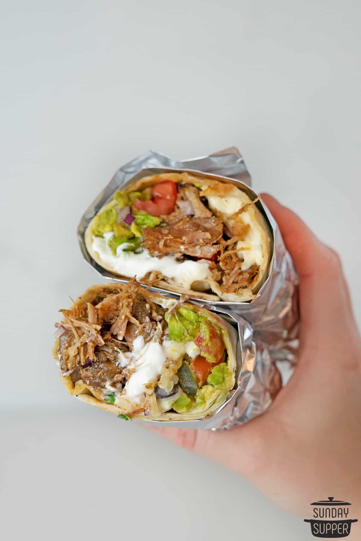 two slices of carnitas burritos wrapped in foil