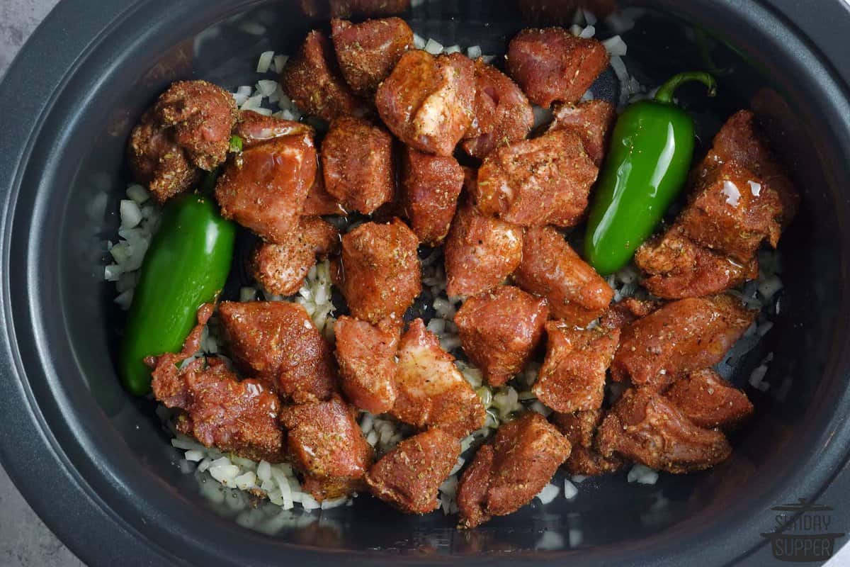 the seasoned pork added to the slow cooker