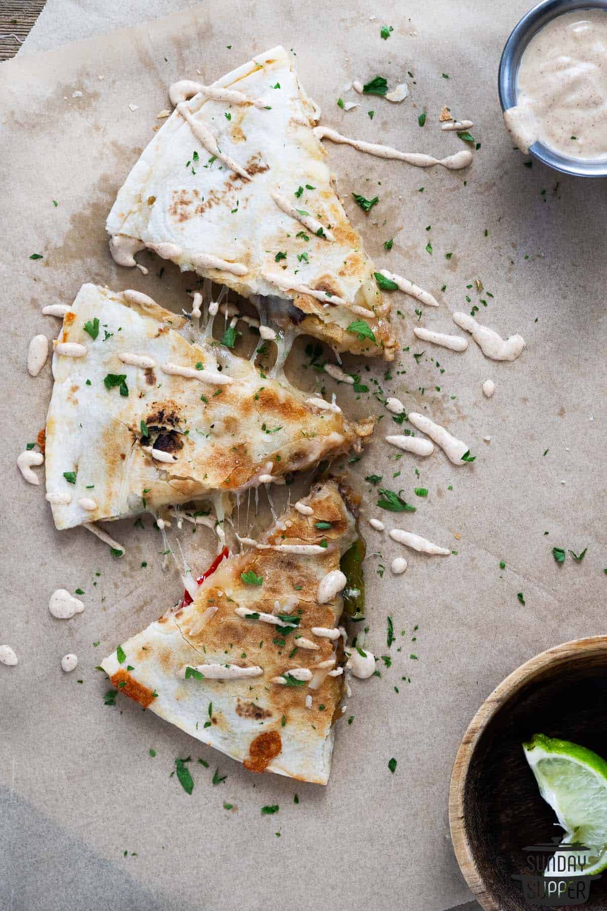 three slices of pulled pork quesadillas with extra sauce