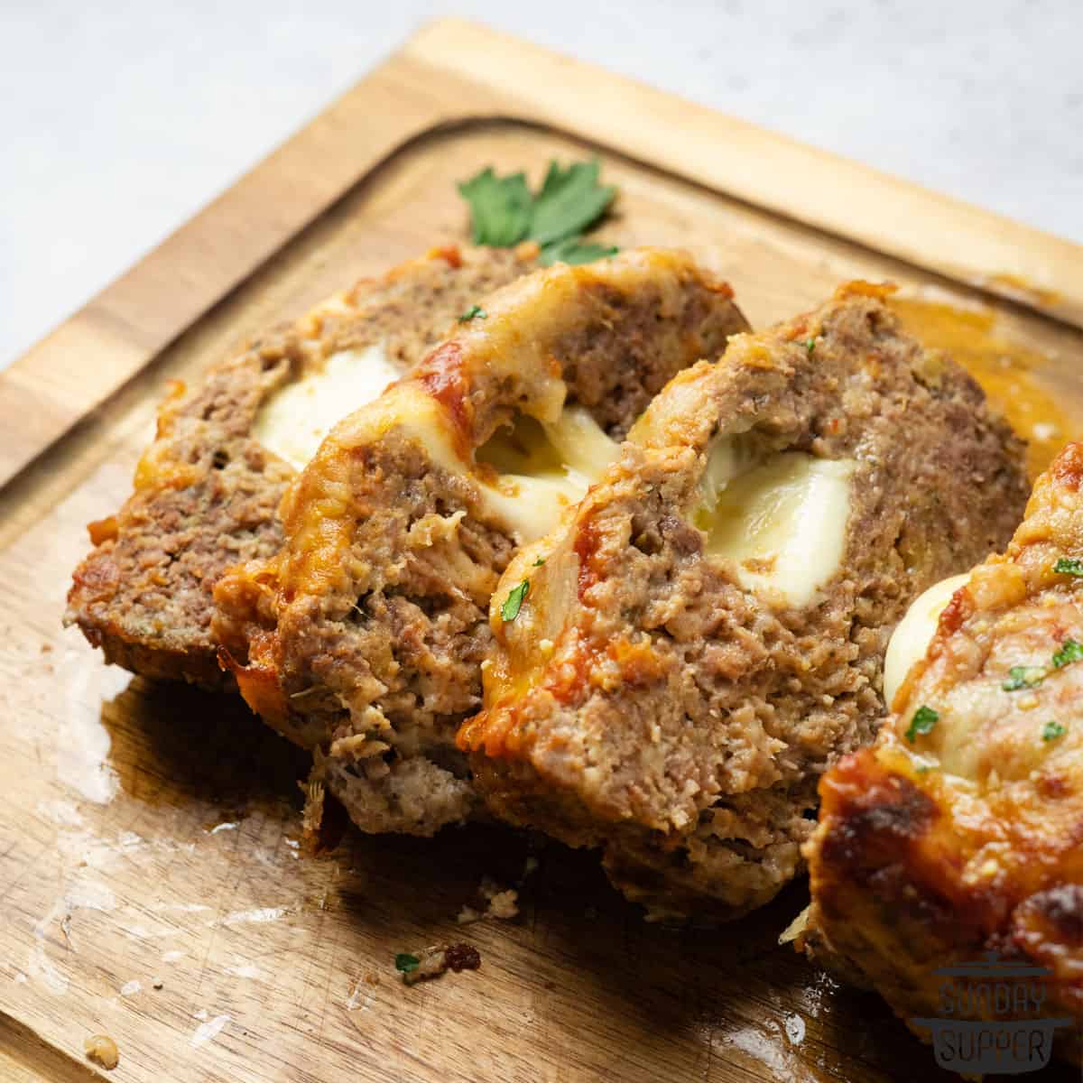 sliced completed italian meatloaf on a cutting board