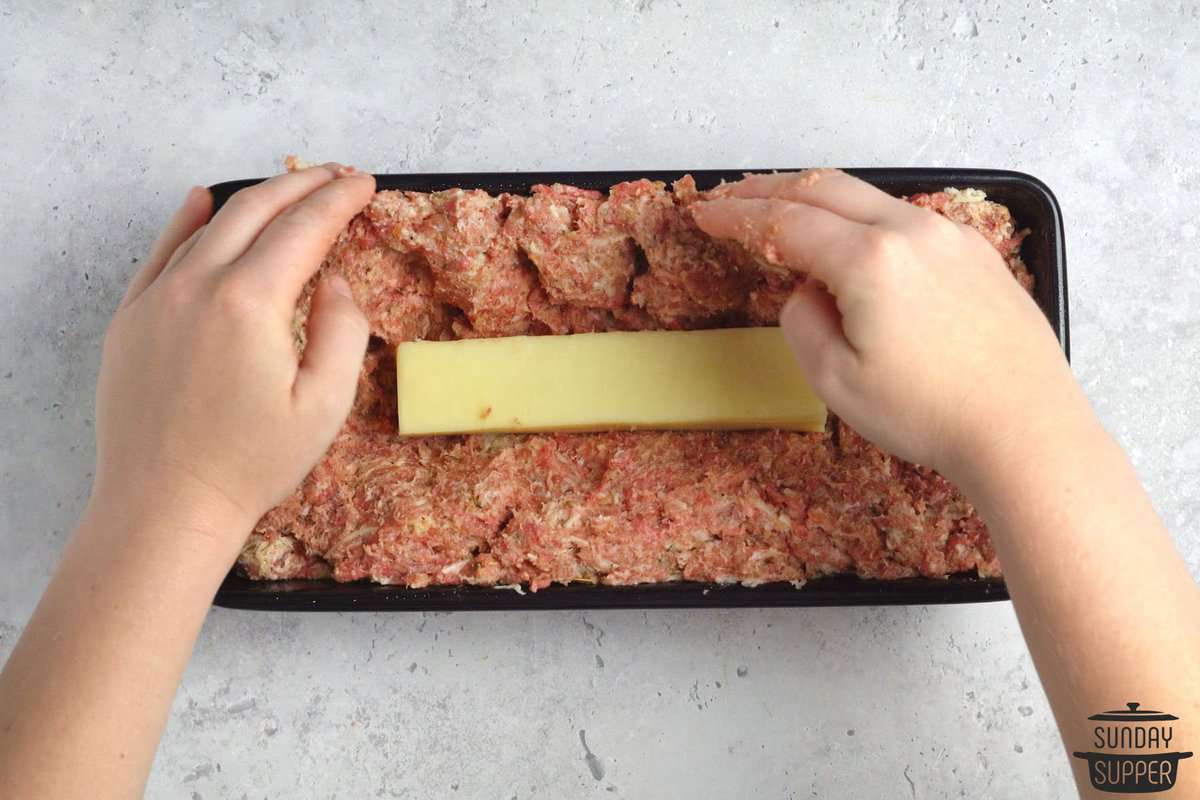 mozzarella being stuffed into the meatloaf