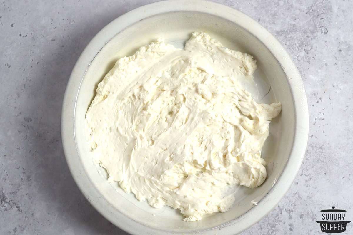 whipped cream cheese spread onto a baking dish