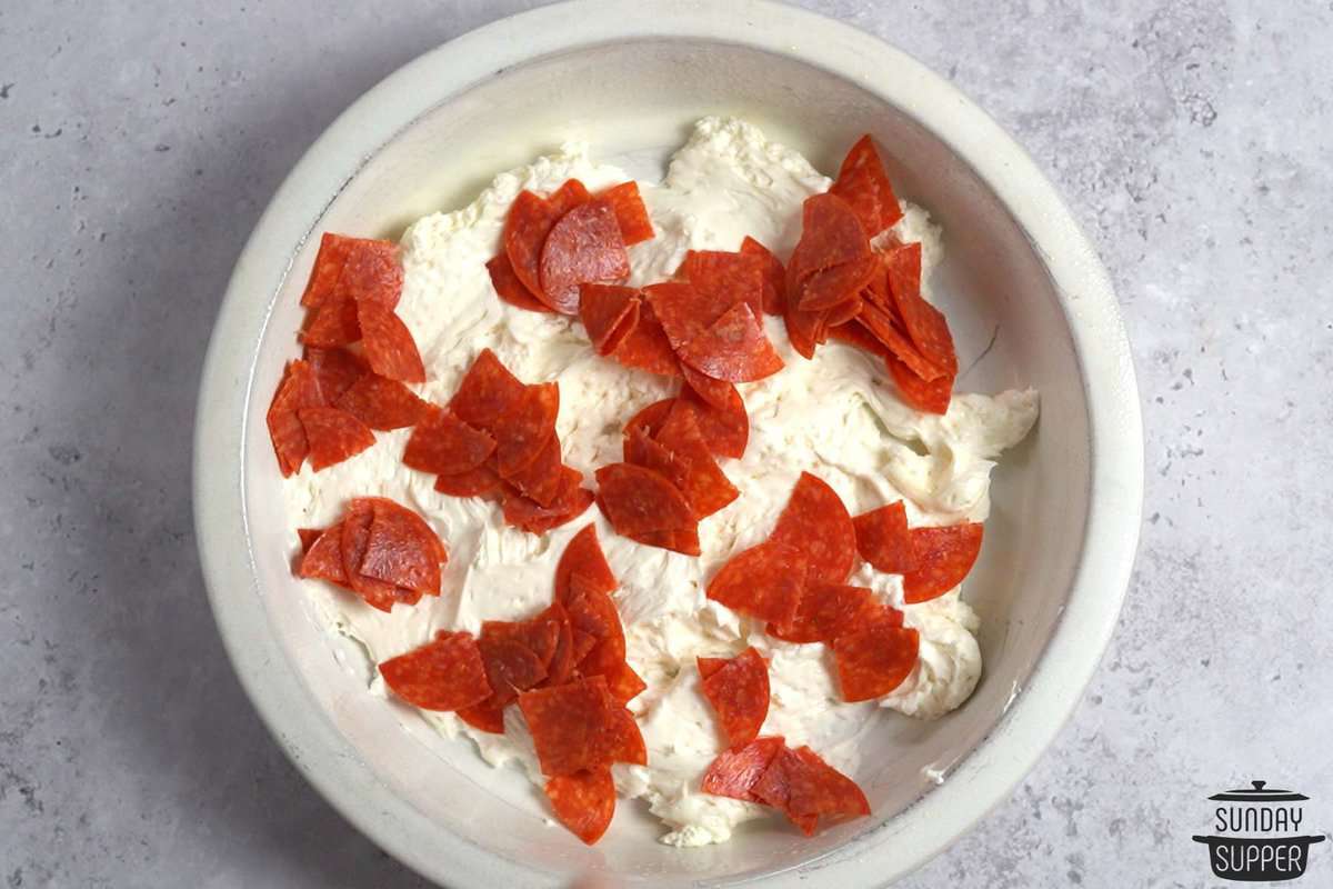 chopped pepperoni on top of whipped cream cheese