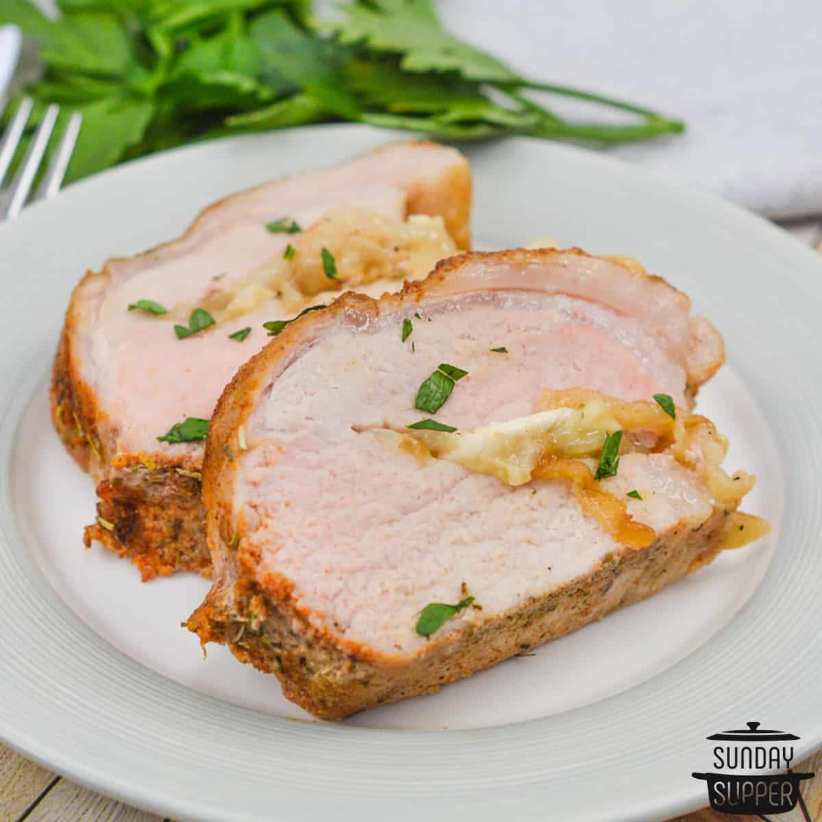 slices of stuffed pork tenderloin to show the cheese and onions