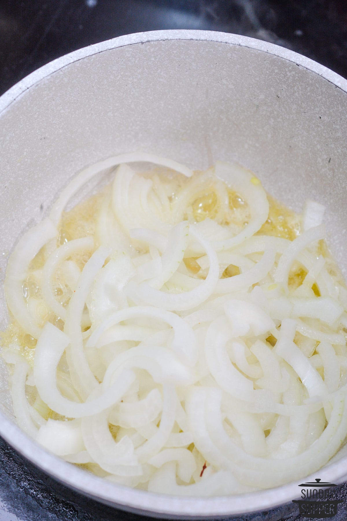 Onions added to the pot of melted butter