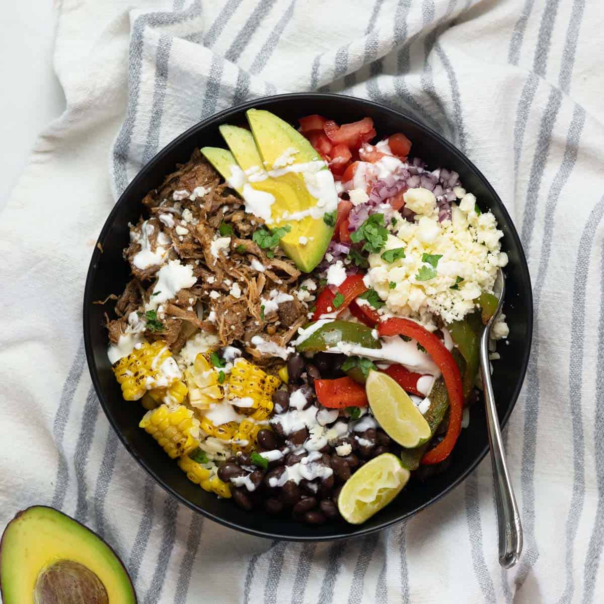 a top down view of a fully completed carnitas burrito bowl