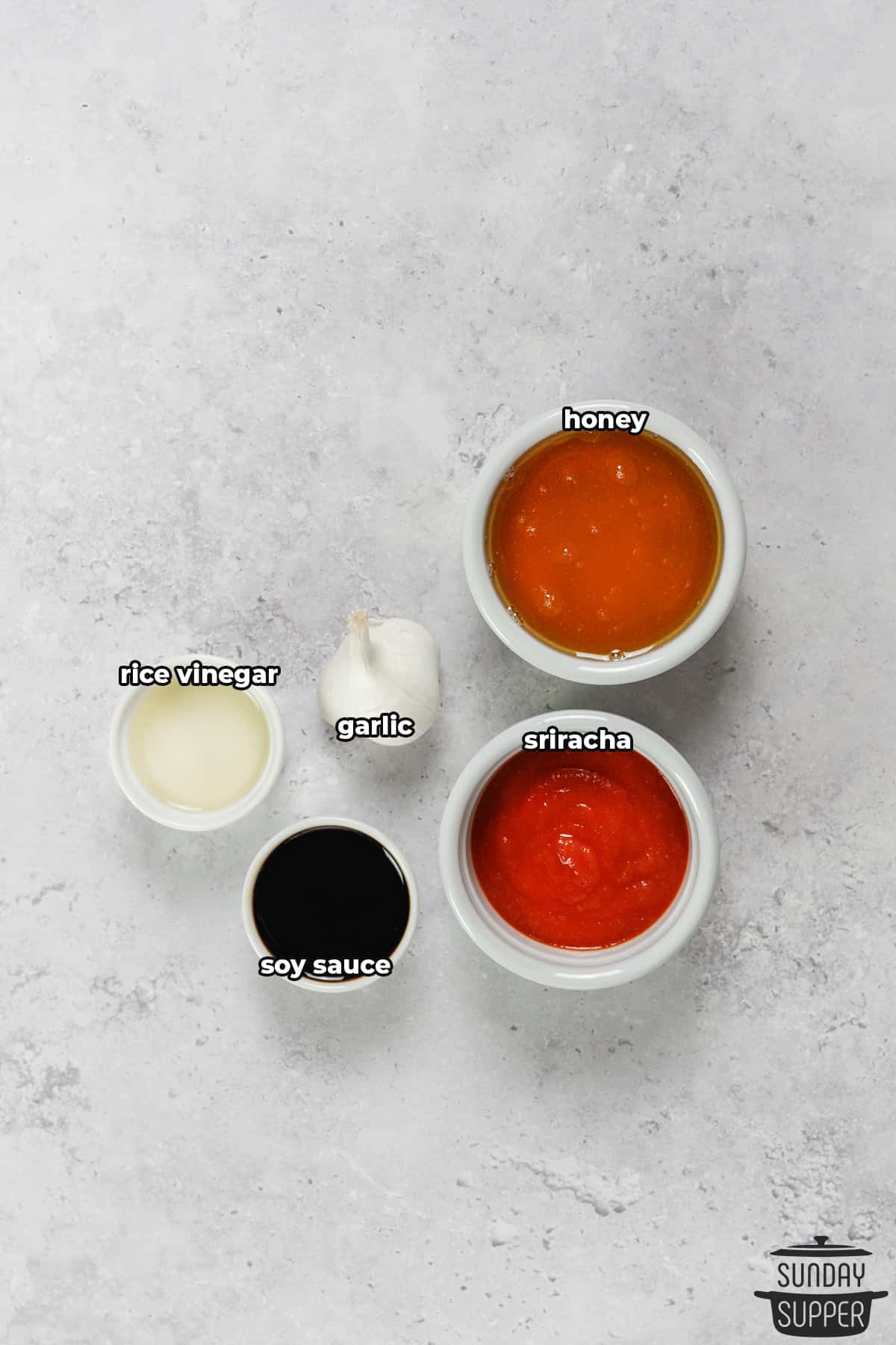 the ingredients for honey sriracha sauce with labels