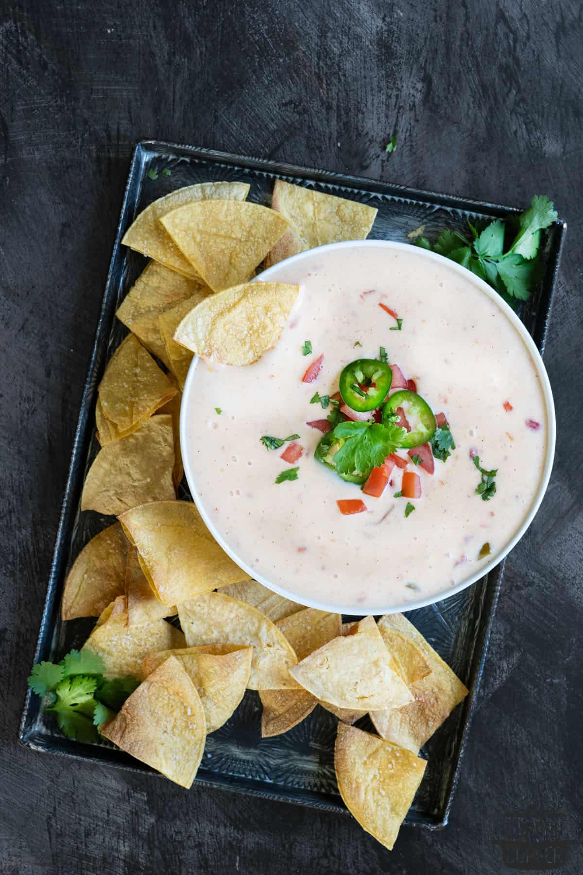 a serving platter of queso blanco and tortilla chips