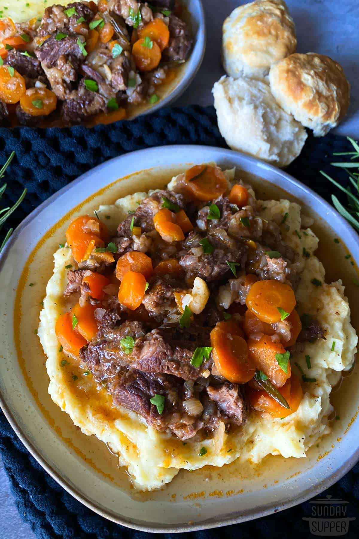 a plate f mashed potatoes topped with short rib stew