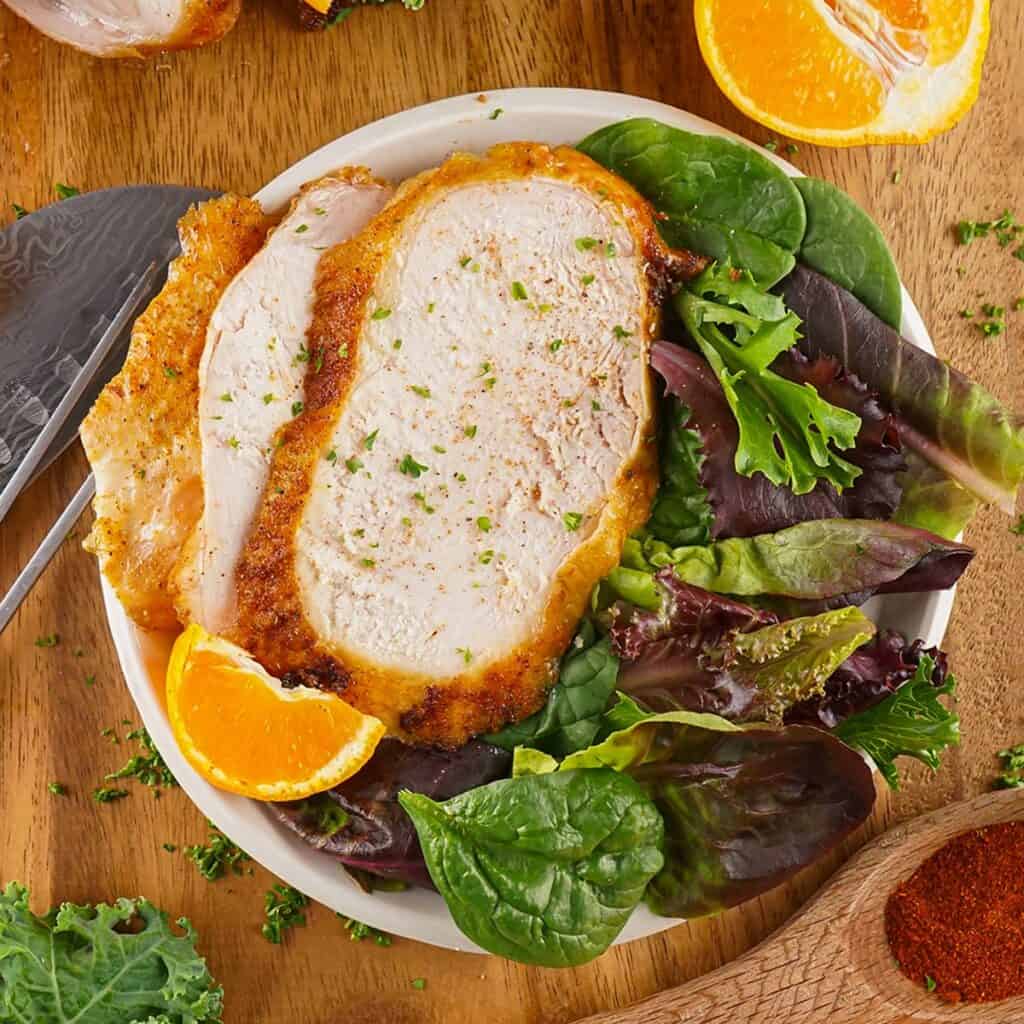 a dinner plate with slices of turkey and lettuce