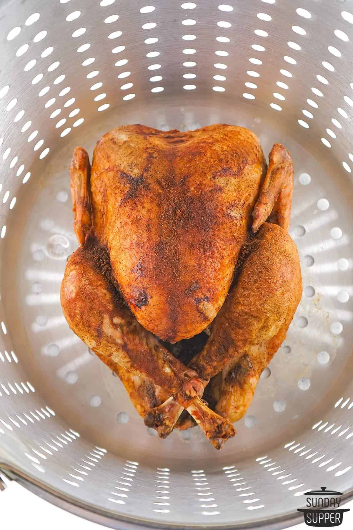 the roasted turkey in a turkey fryer basket
