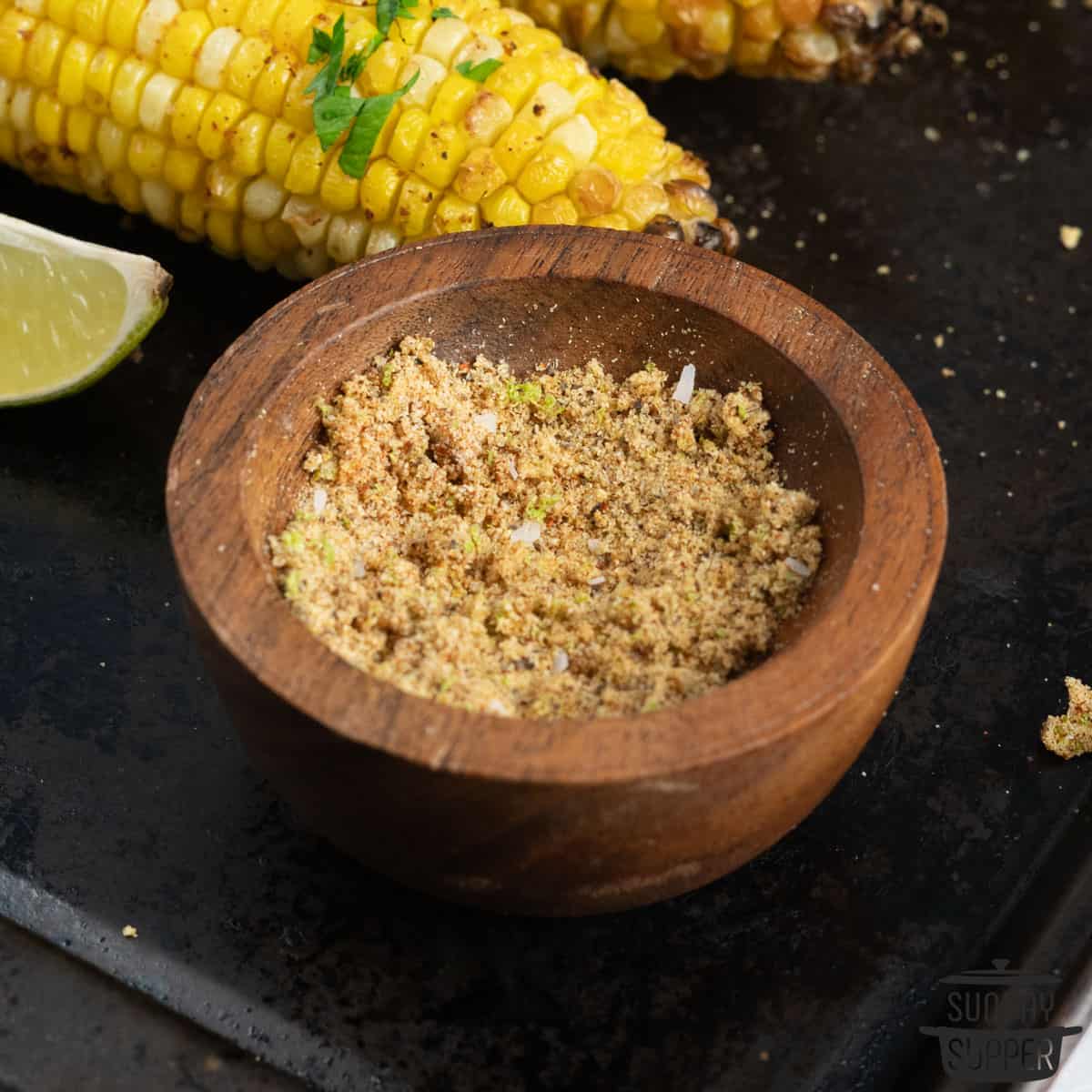 a small bowl of mixed corn on the cob seasoning
