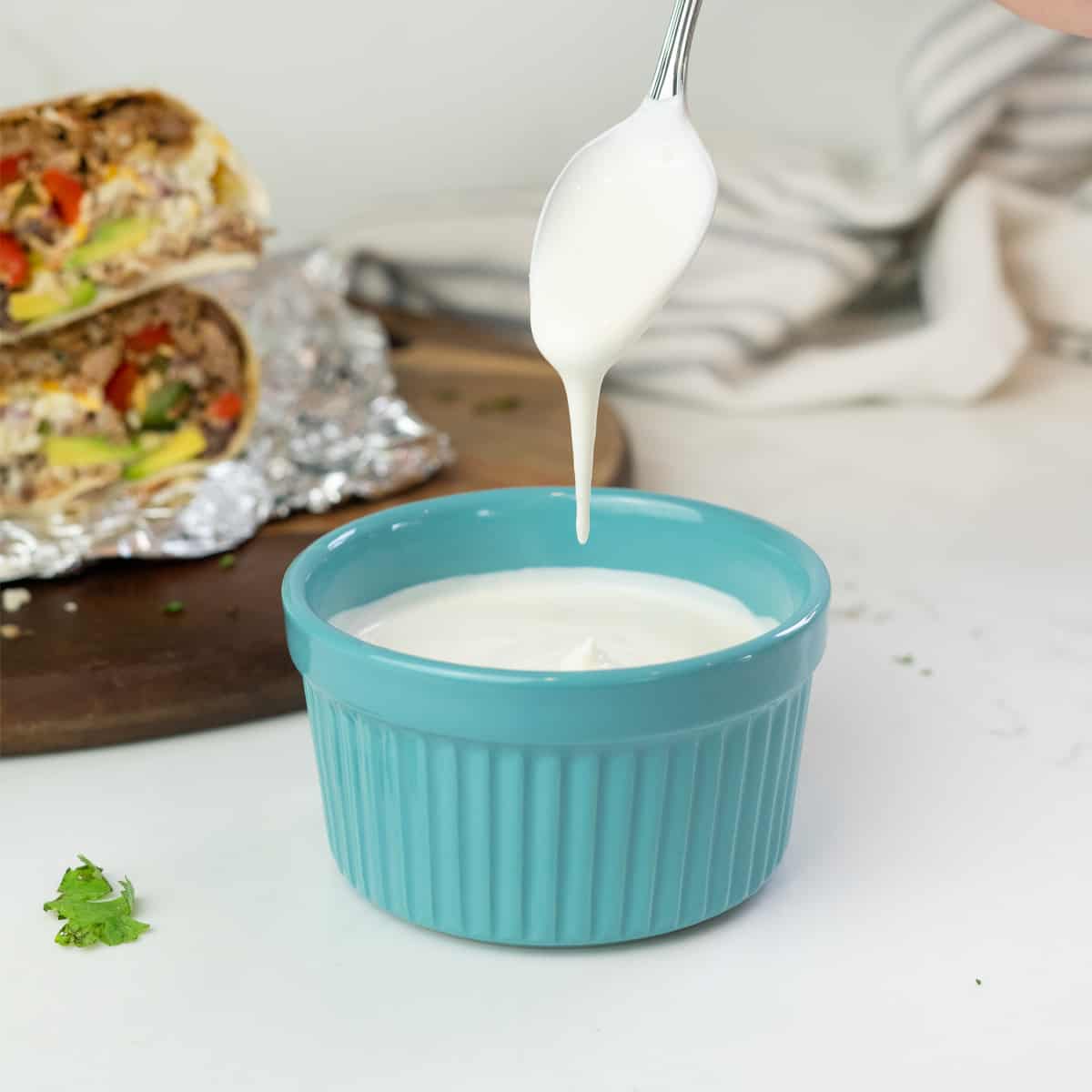 a spoon dripping crema into a bowl