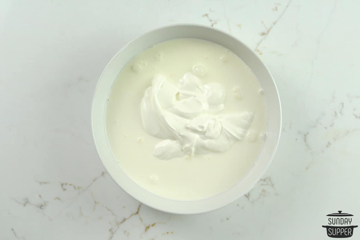 the sour cream and heavy cream combined in a bowl