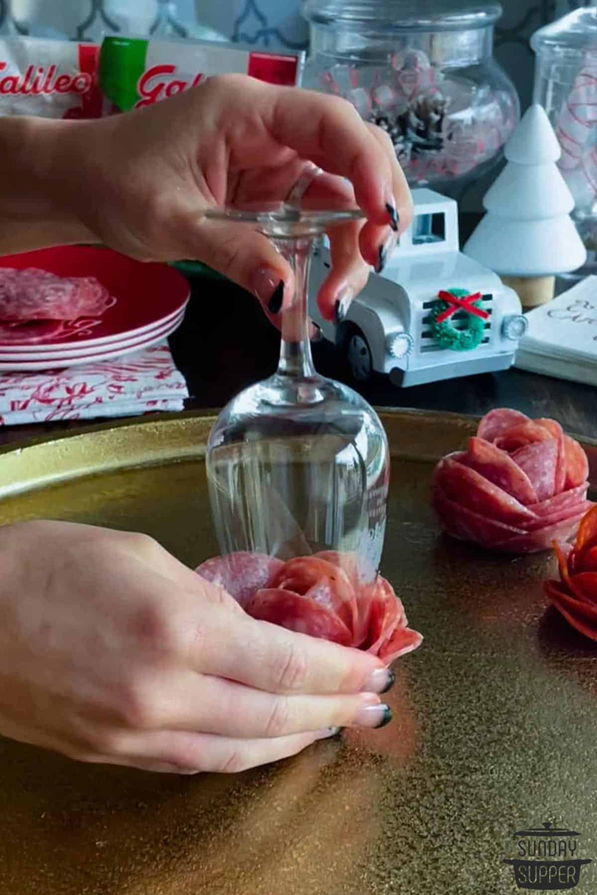the glass flipped over to loosen the salami rose