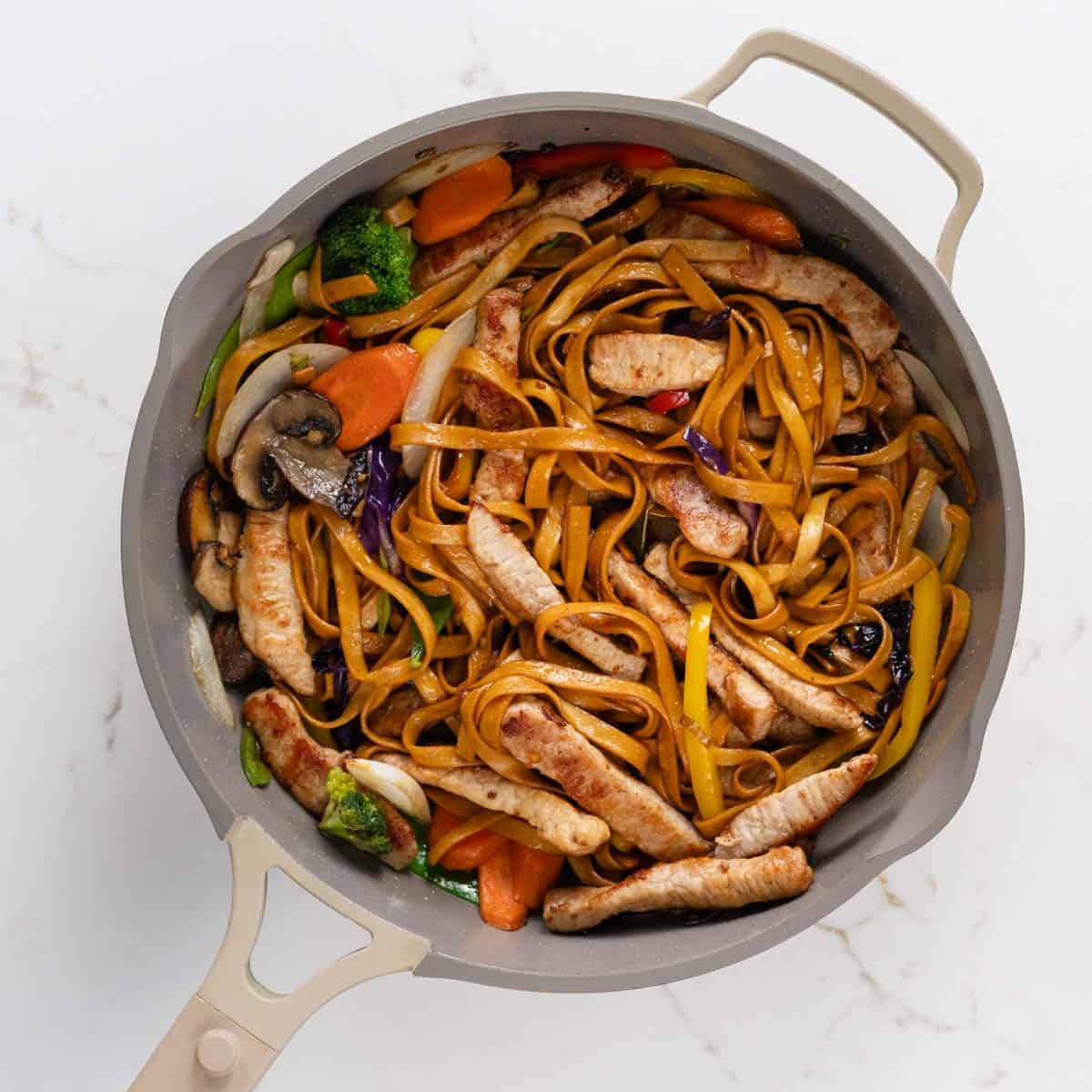 close up of pork stir fry inside of a skillet