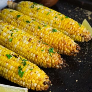 four ears of air fried corn on a plate