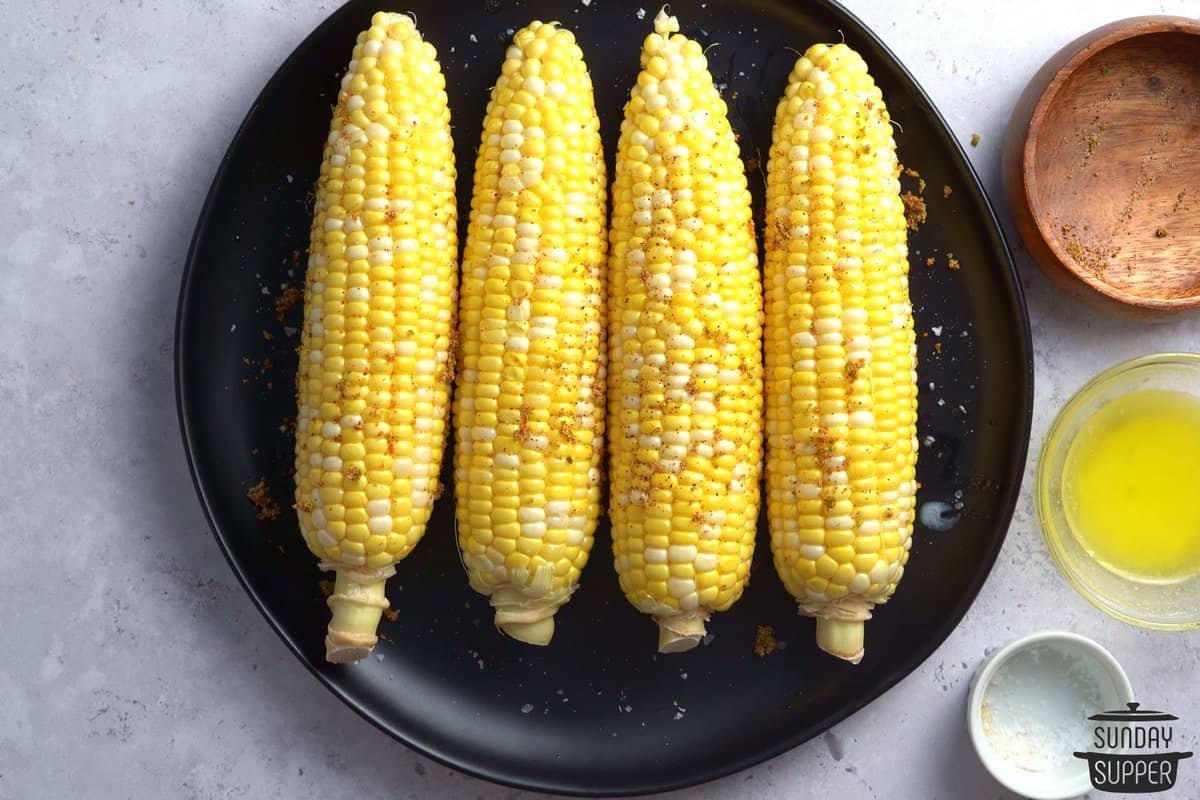 seasonings sprinkled on raw corn