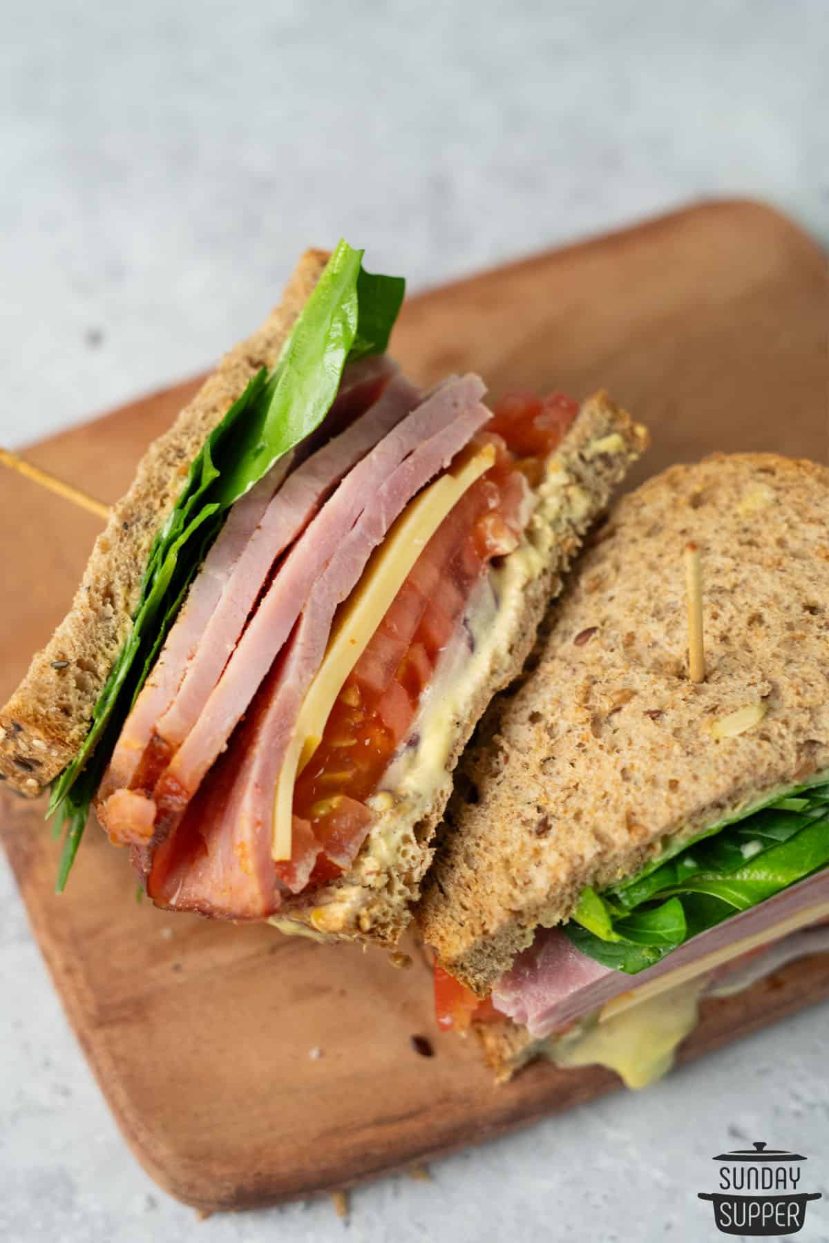 two ham sandwich halves skewered with toothpicks