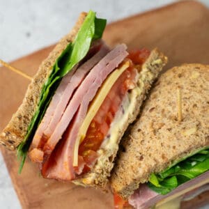 a closeup of two halves of a ham sandwich