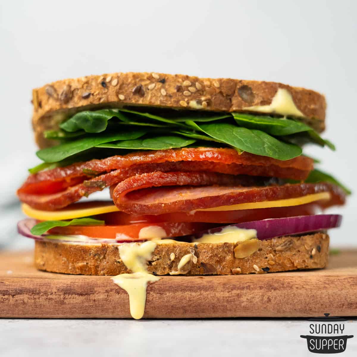 a ham sandwich assembled on a cutting board