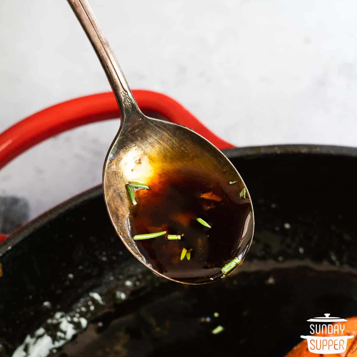 a spoon of hone garlic sauce over a pan