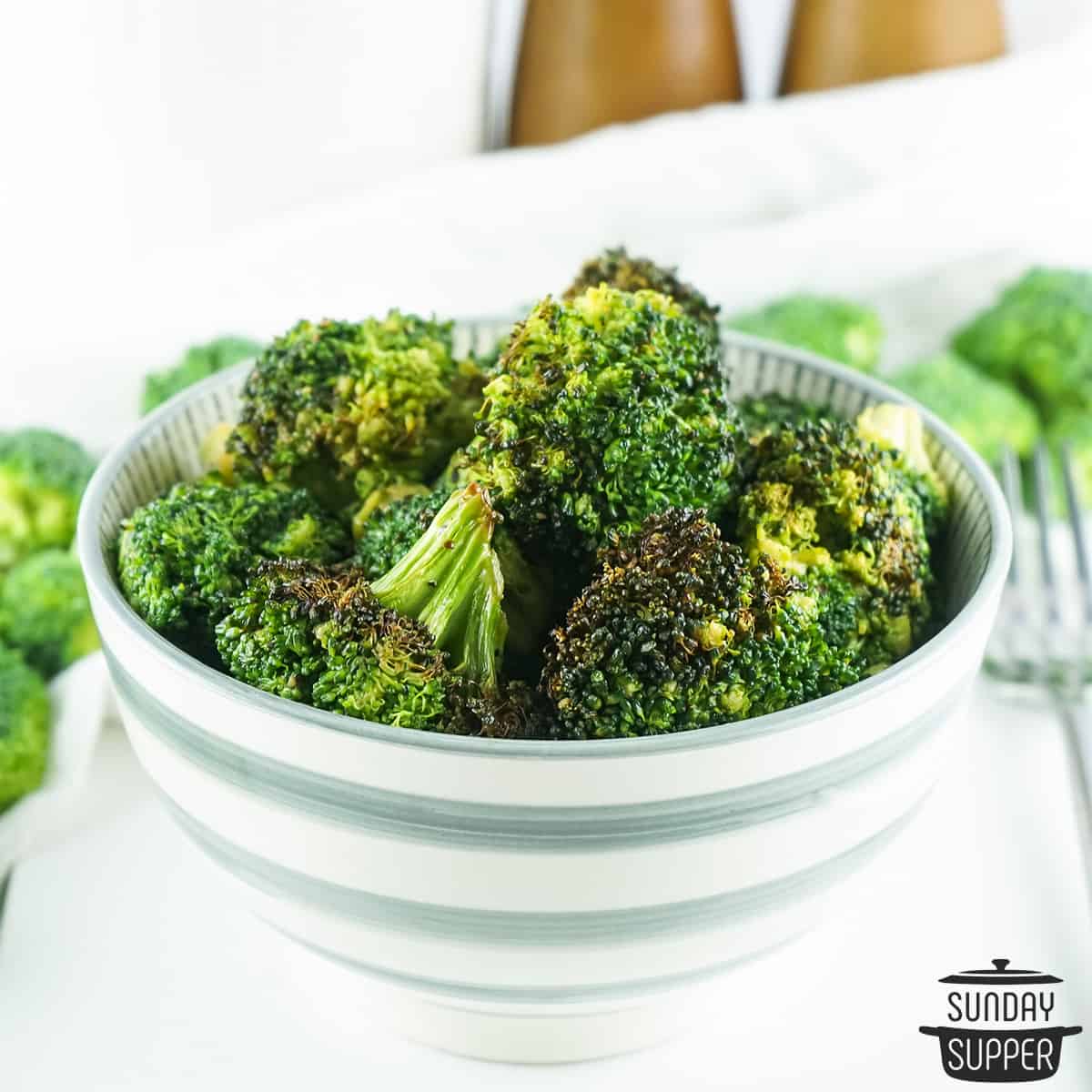 a small white bowl of air fryer broccoli