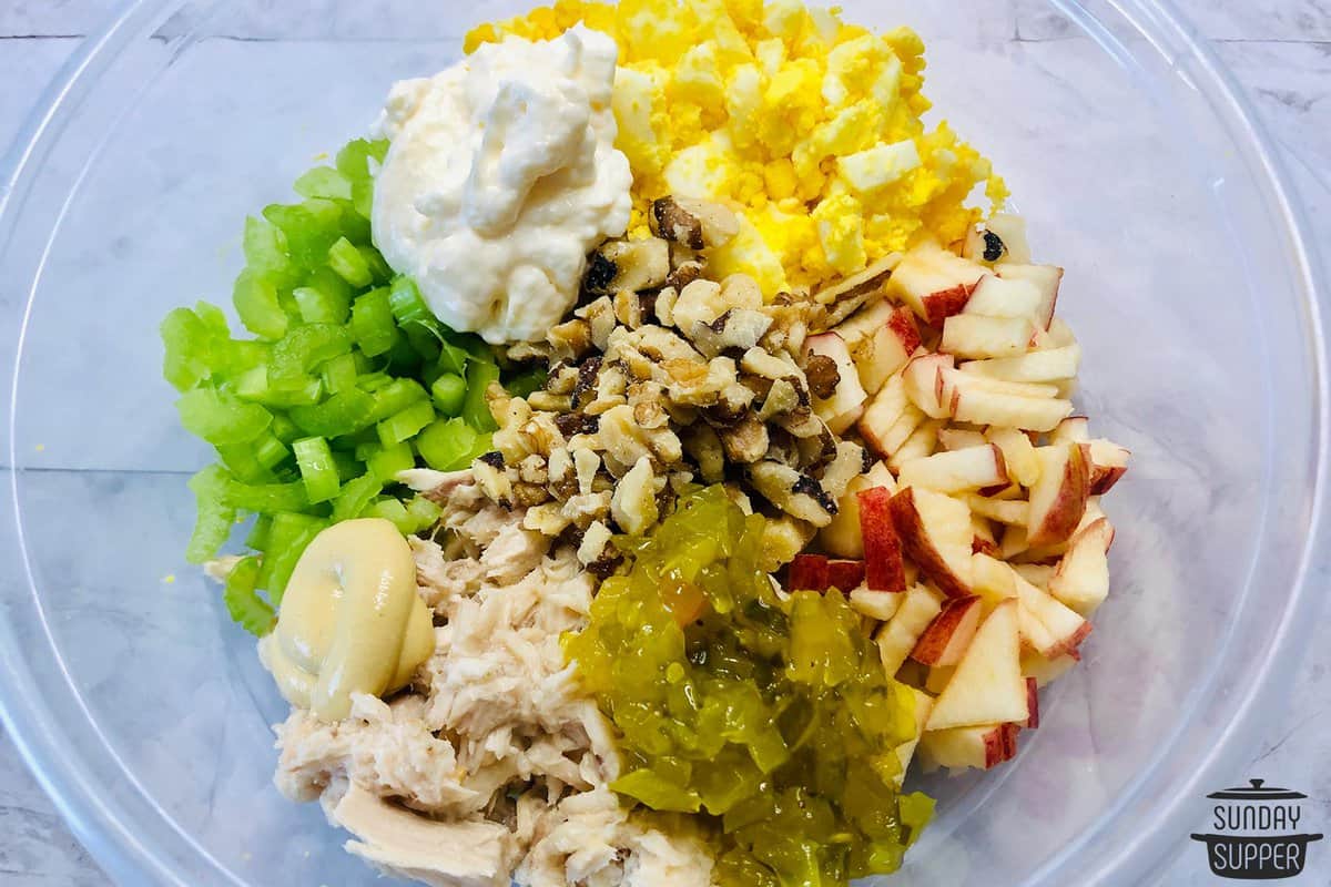 all the apple tuna salad ingredients added to a bowl