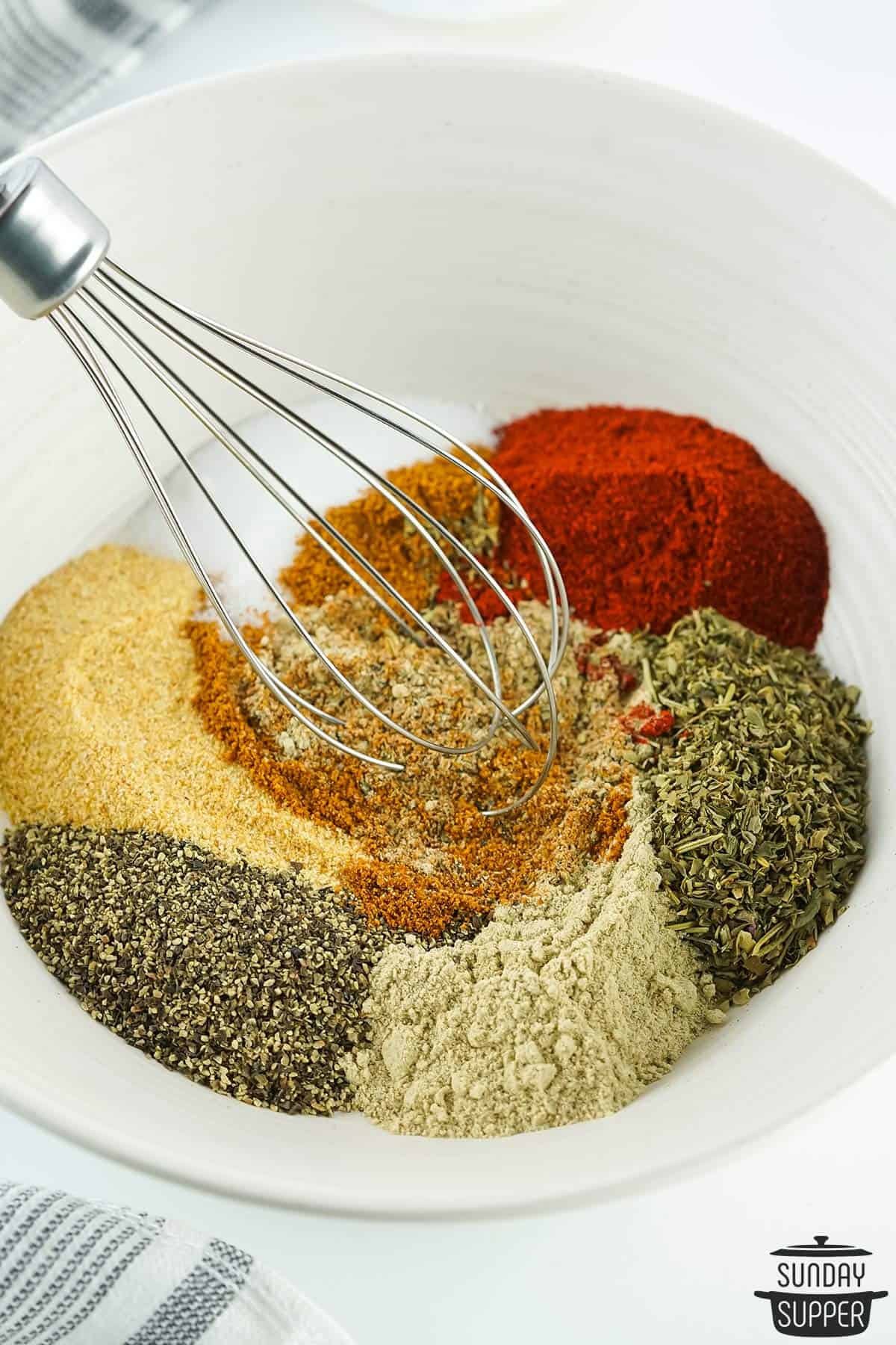the seasonings being whisked in a bowl