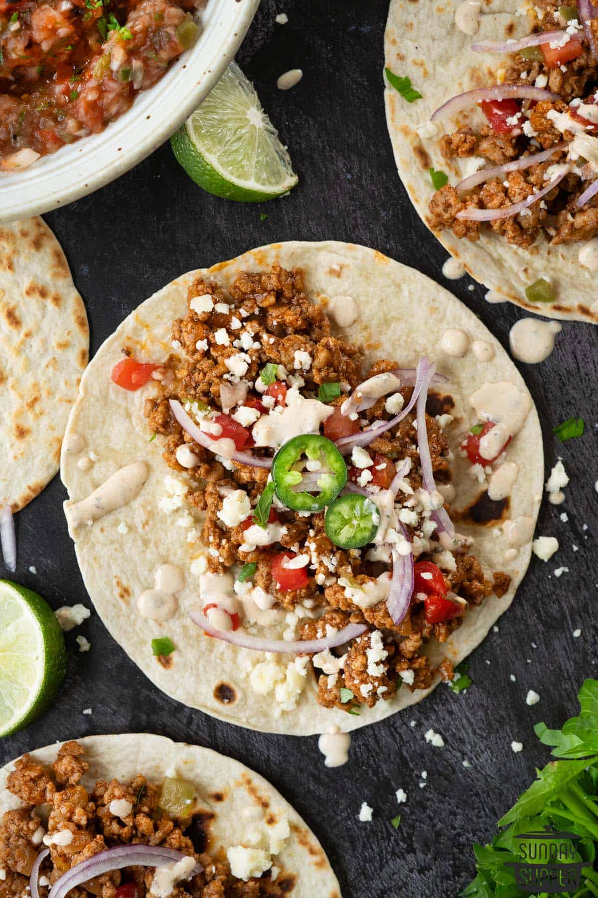 chipotle ranch drizzled over assembled tacos