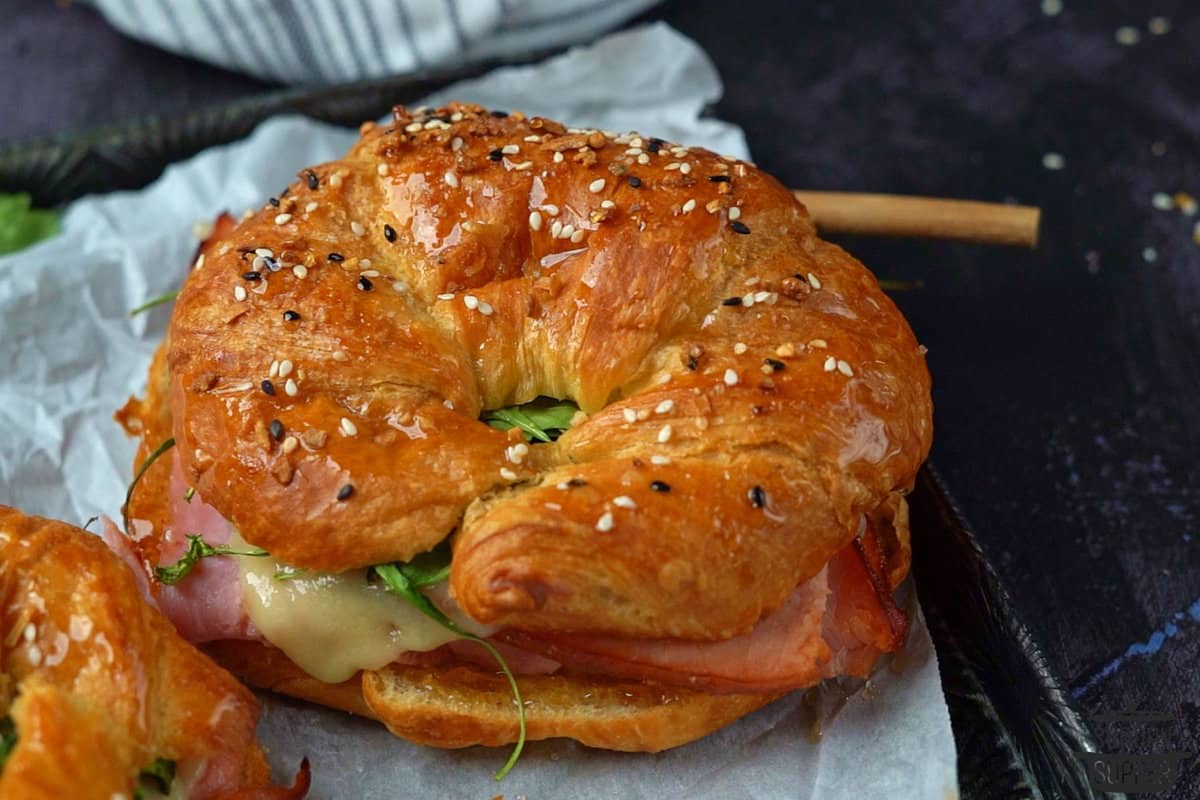 ham and cheese croissant on parchment paper