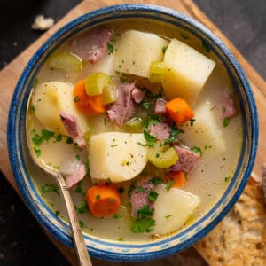 ham bone soup in a bowl with a spoon inside