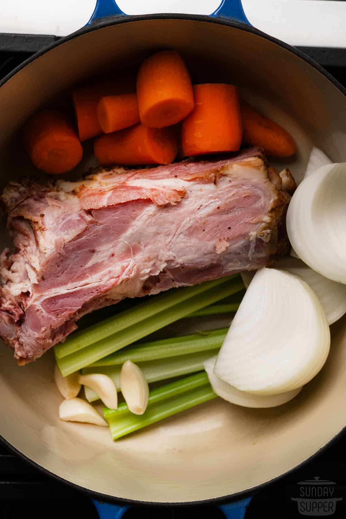ham stock ingredients inside of a pan