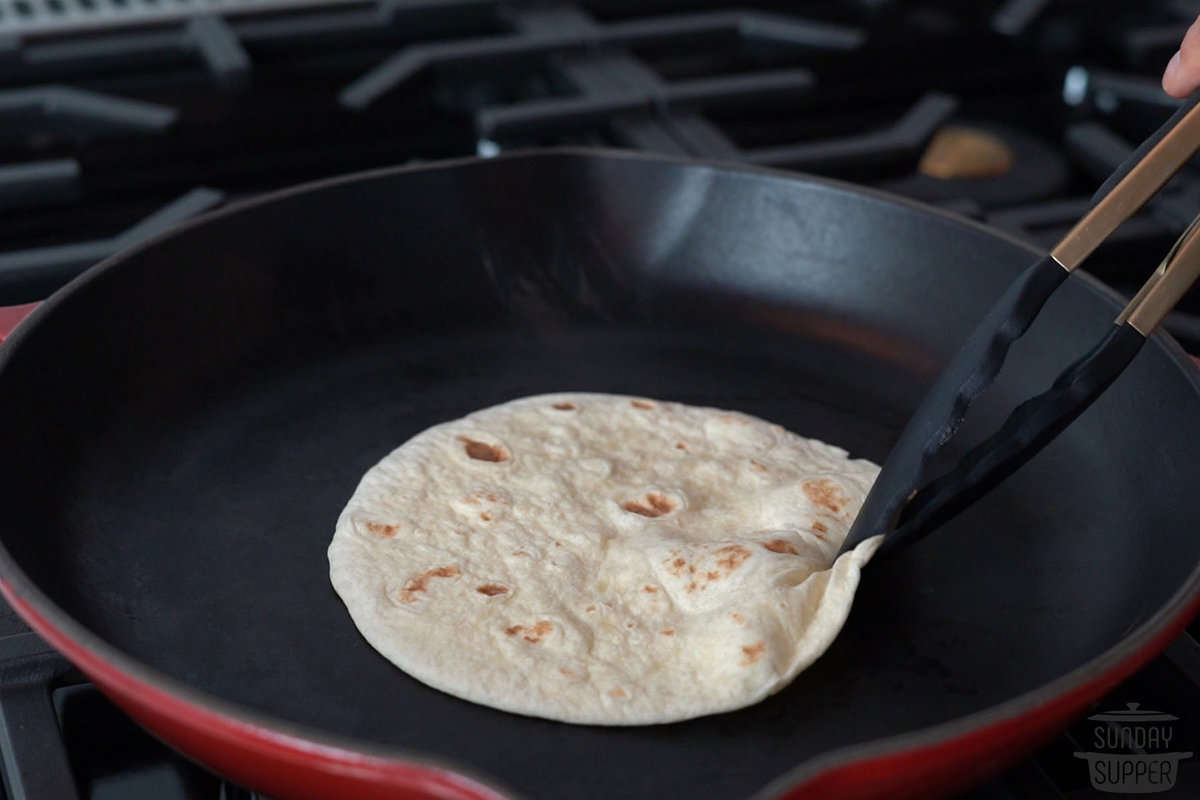 a tortilla placed on a hot pan
