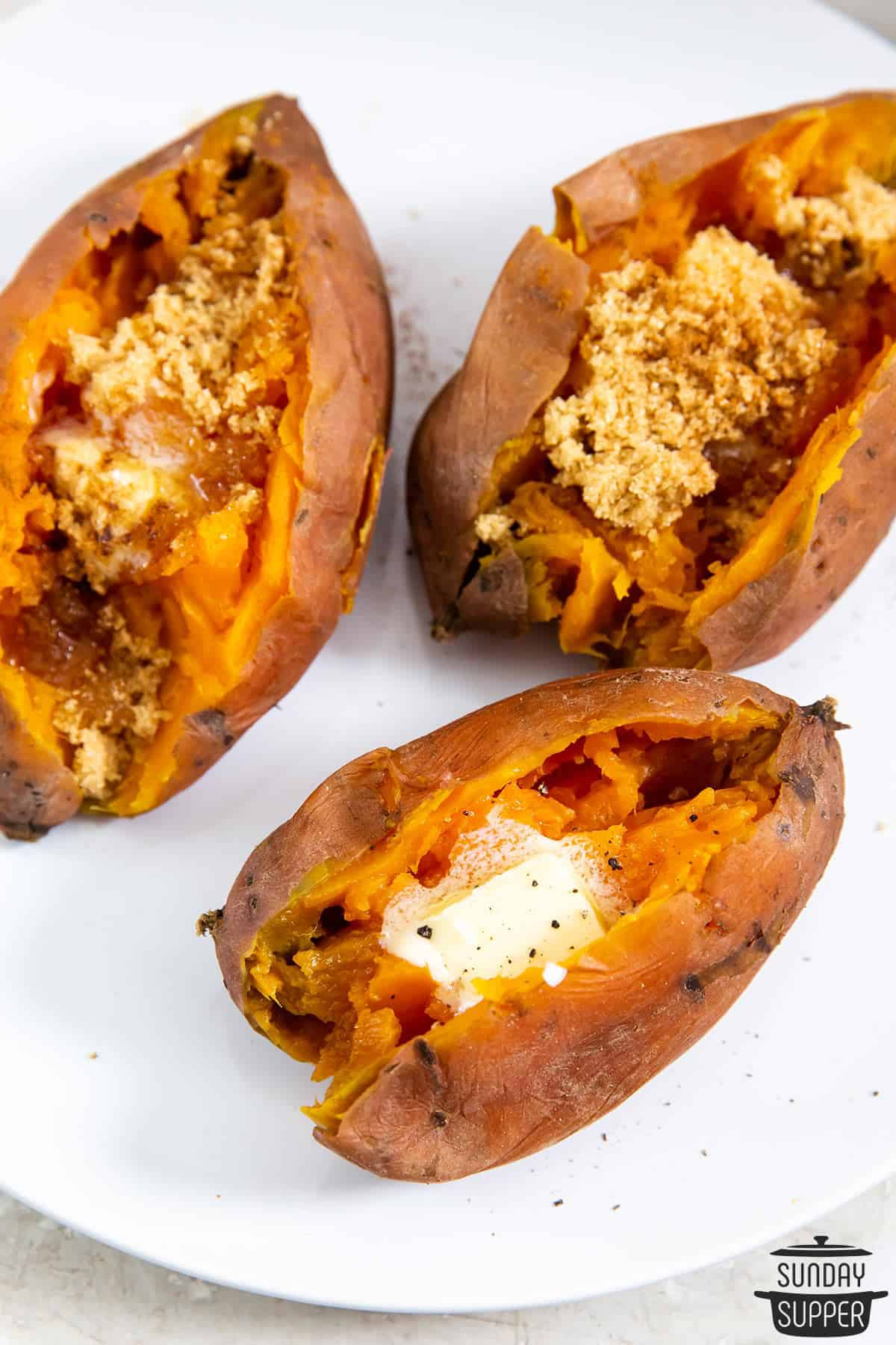 three sweet potatoes with different toppings on a plate