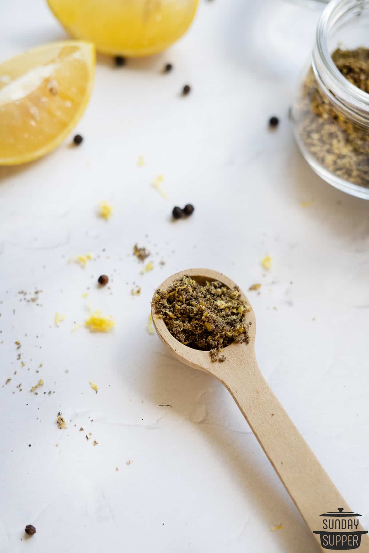 a serving spoon filled with lemon pepper seasoning