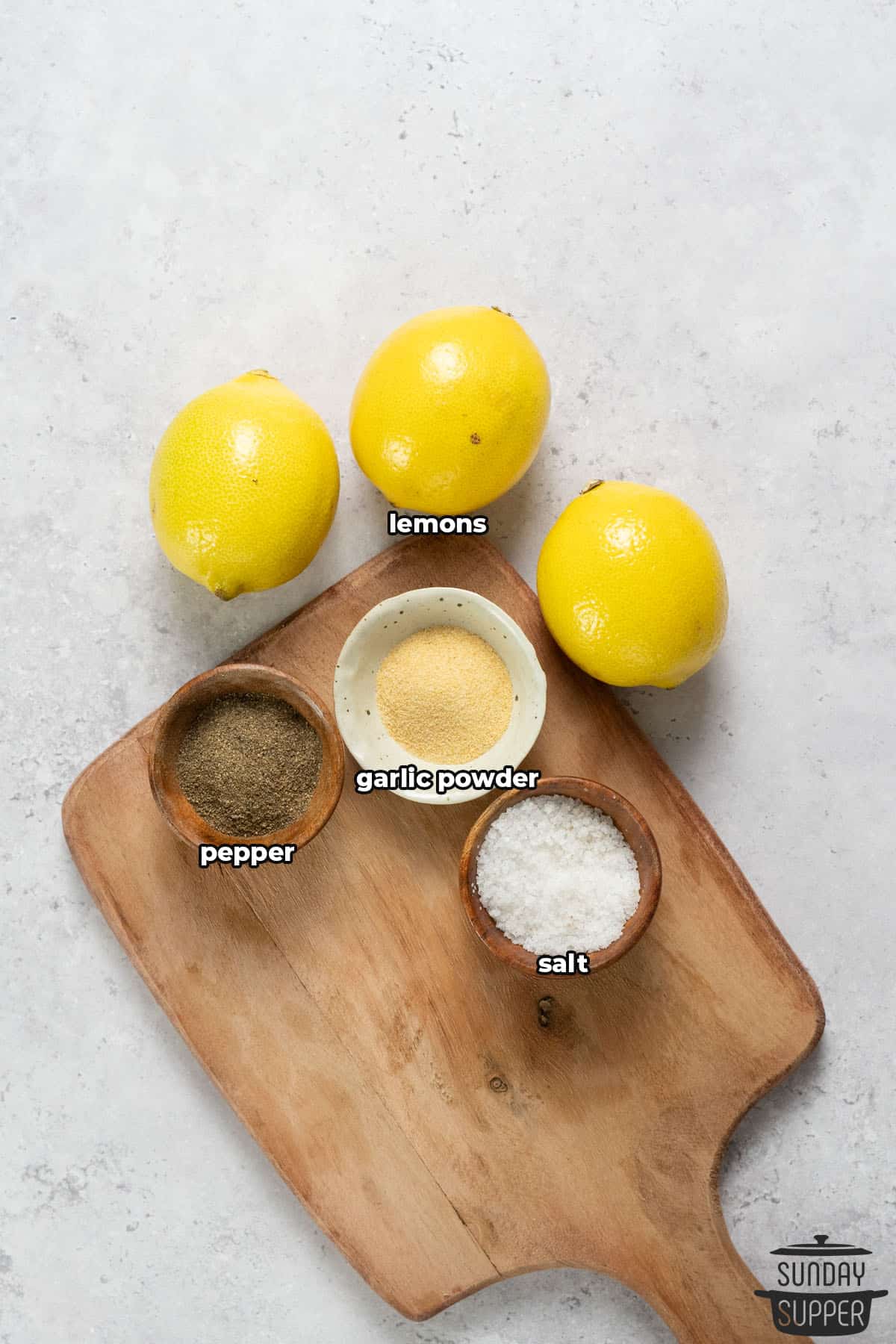 all the ingredients for lemon pepper seasoning with labels